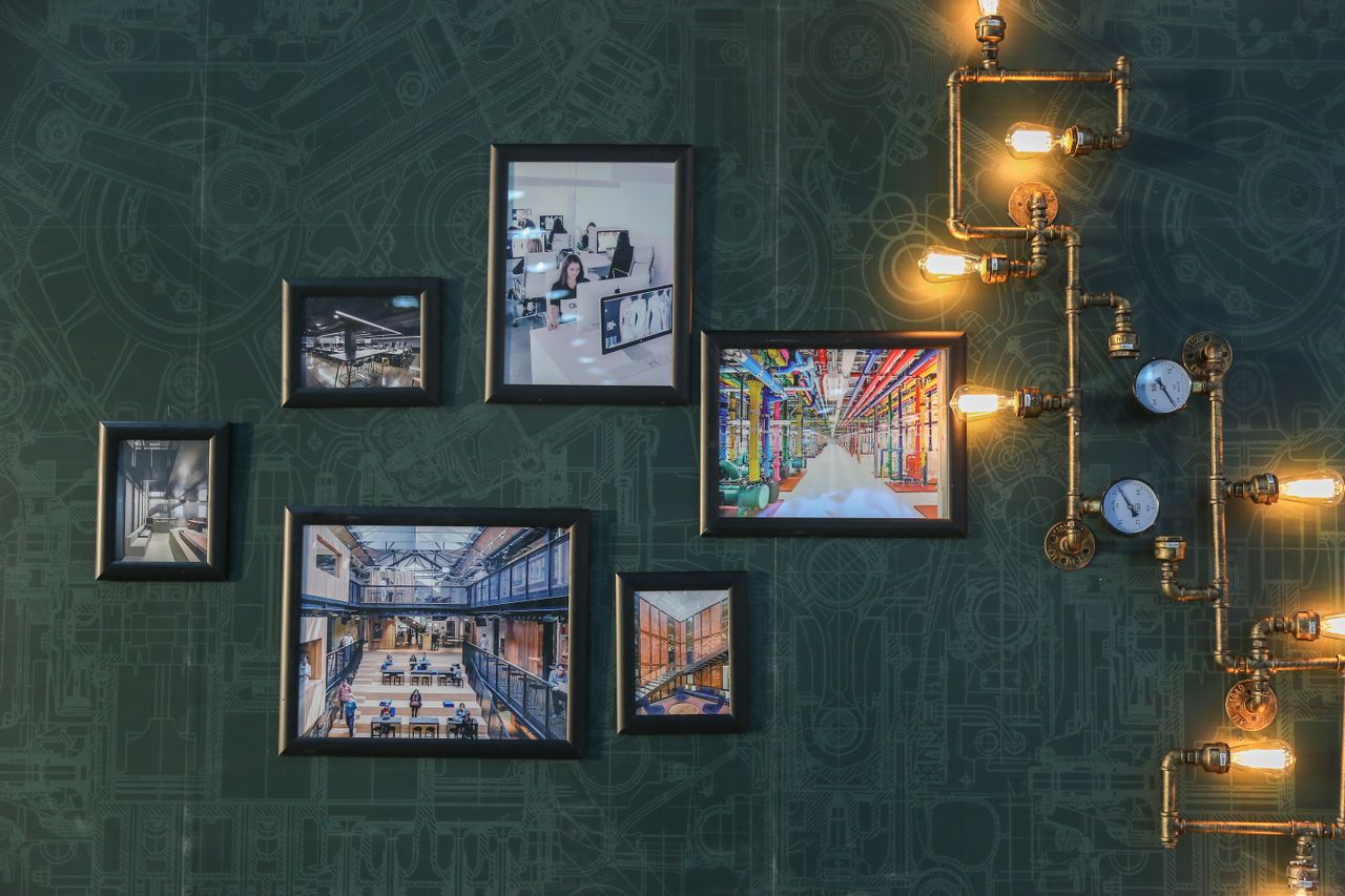 gallery-05 Industrial style wall art with vintage pipe lighting on a green textured wall adds a unique touch.